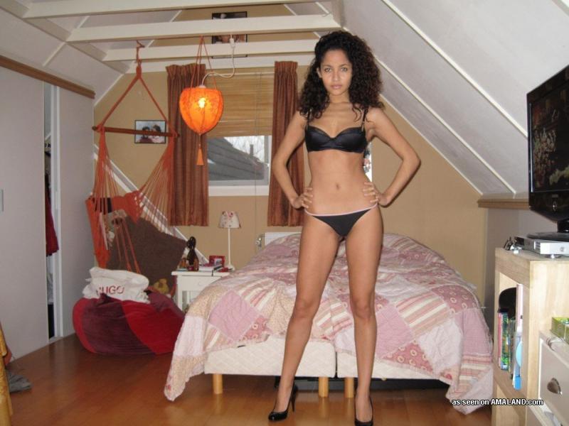 Latina chick stripteasing in her room
